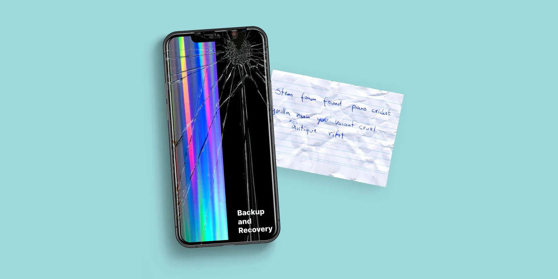 A broken phone next to a crypto wallet recovery phrase written on a piece of paper